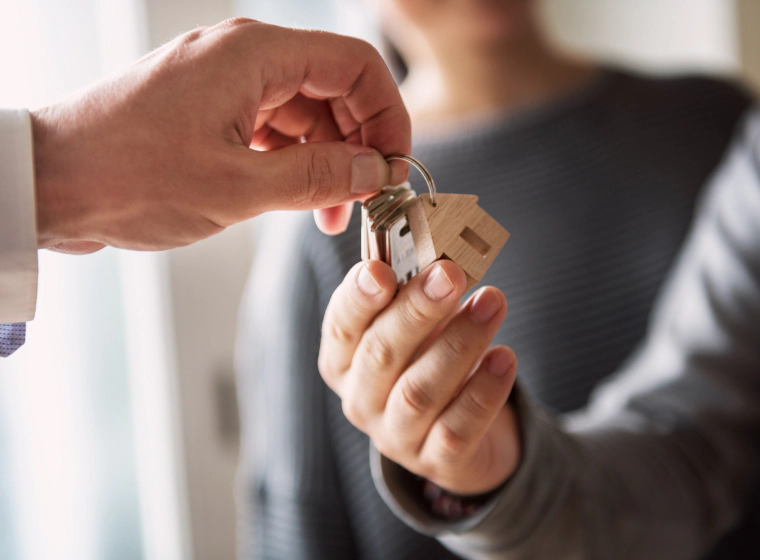 man handing over key to new owner of house valencia pa